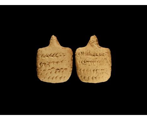 An undated archaistic ceramic pillow-shaped tablet with integral suspension loop to the top; both faces and edges incised wit