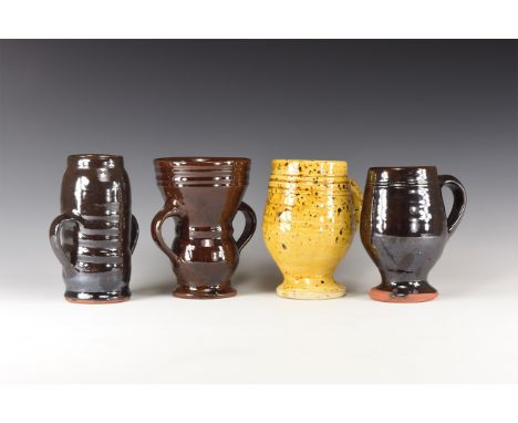 20th century AD. A mixed group of four glazed ceramic cups, one with two strap handles and a ribbed mouth; attributed to Trin