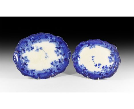 20th century AD. A pair of glazed ceramic platters, each with blue-glazed scrolled outer and white centre with blossom; stamp