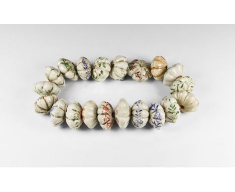 20th century AD. A restrung group of twenty glazed ceramic graduated melon beads with floral detailing.  990 grams total, 52c