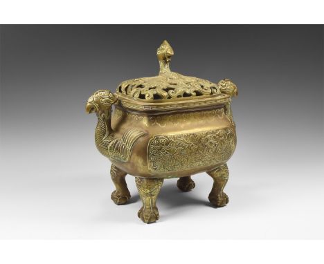 An undated archaistic bronze incense burner comprising a rounded rectangular body with waisted neck, four claw feet each clut