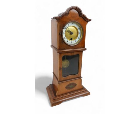A mahogany mantle clock in the form of a long case clock, 22 by 14 by 46cm high.