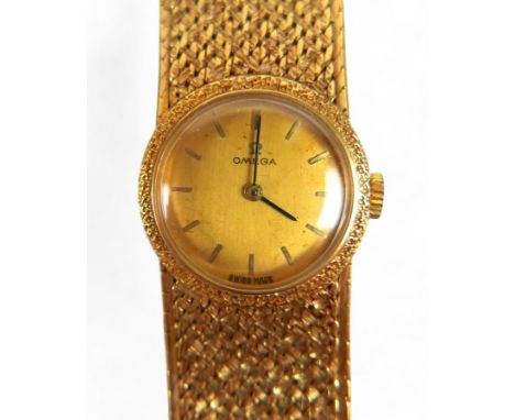An Omega 18ct yellow gold ladies bracelet wristwatch, manual wind, 21mm case, 18cm long, weight 57.9g, currently running.