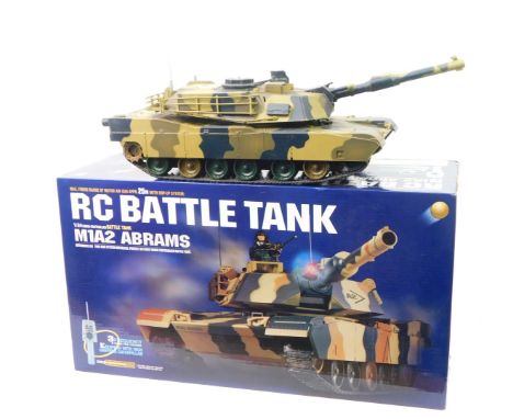 An RC Battle Tank, M1A2 Abrams 1/24 scale, with remote control, boxed.