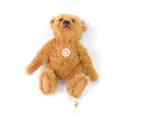 A Steiff plush jointed teddy bear, in brown with growl action, label to the ear, 32cm high.