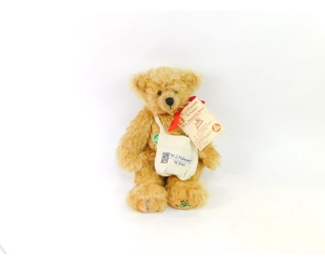 A Hermann Hummel 70 year anniversary plush jointed teddy bear, with red bow and paperwork, 34cm high.