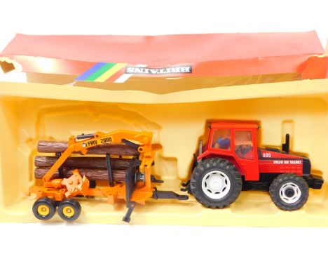 A Britains die cast Volvo Tractor 9609 and log transporter, 9609, boxed.
