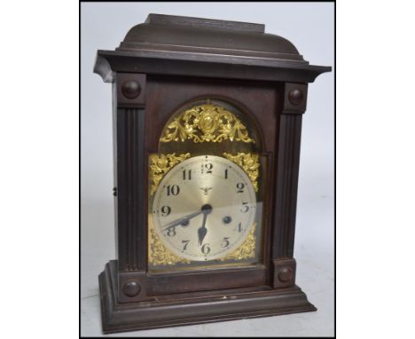 An early 20th century Edwardian English cased bracket clock having a German FMS 8 day movement striking on a gong with pendul