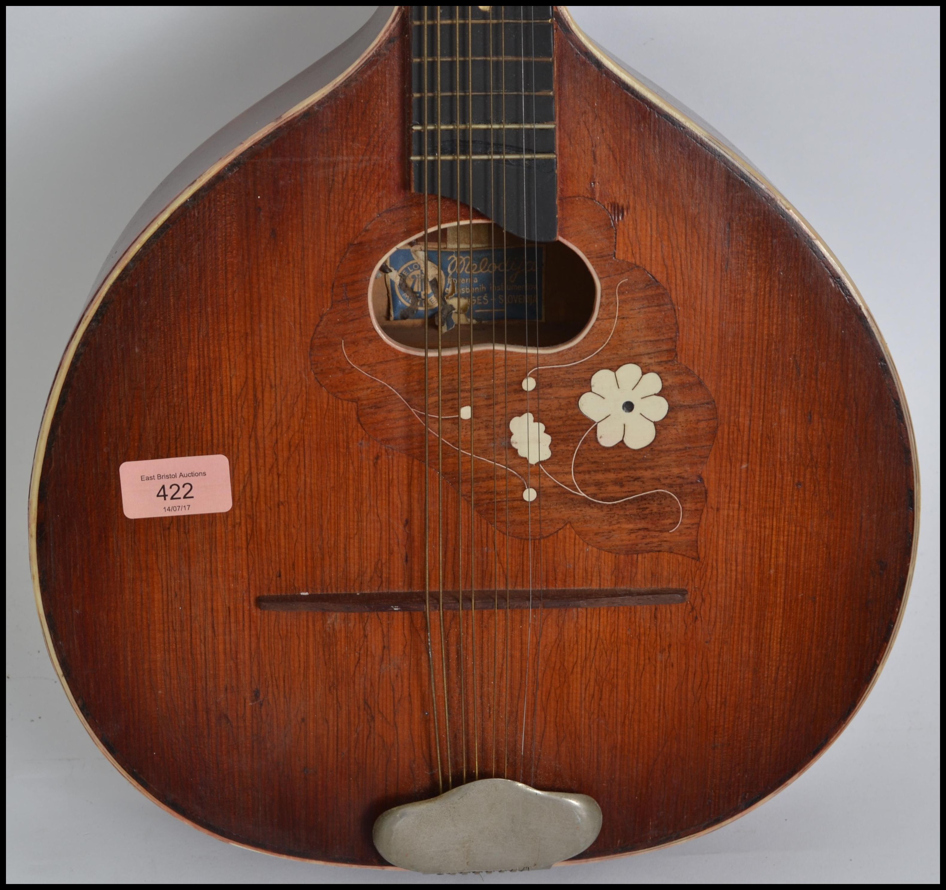 A vintage early 20th century 8 string mandolin guitar having a shaped