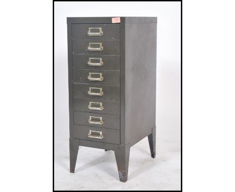 A vintage / retro industrial upright metal eight short drawer filing cabinet, shaped supports having notation slides and loop