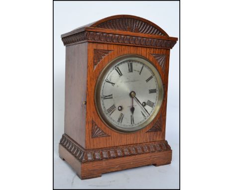 An Edwardian oak cased bracket clock by Courlander of Croydon London. The silvered dial with roman numeral chapter ring, 8 da