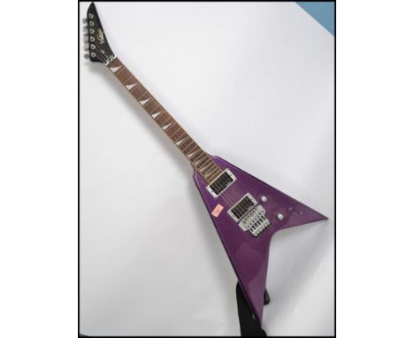 A vintage style 6 string electric axe shaped 5 way guitar having a shaped body with sloped mother of pearl fret markers. Meas