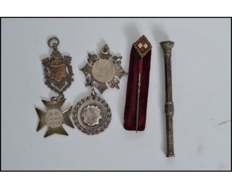 A group of silver hallmarked fobs, a silver pusher pencil and a masonic agate stick pin brooch, one fob with inscription for 