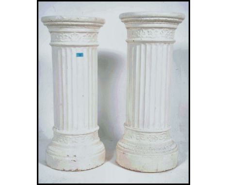 A large pair of neo-classical ceramic white painted bust stands / plant stands having columns with plinths top and bottom. Me