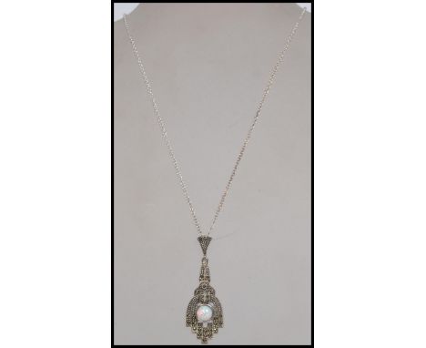 A silver Art Deco style ladies marcasite and opal necklace pendant and chain complete in the presentation box. 44cms long cha