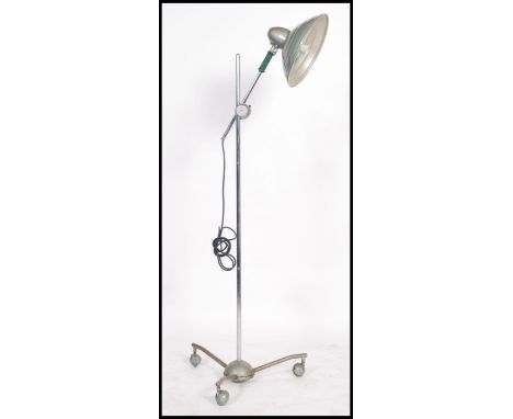 A vintage retro 20th century industrial floor standing lamp raised on a tubular atomic style tripod base with a ridged pendan