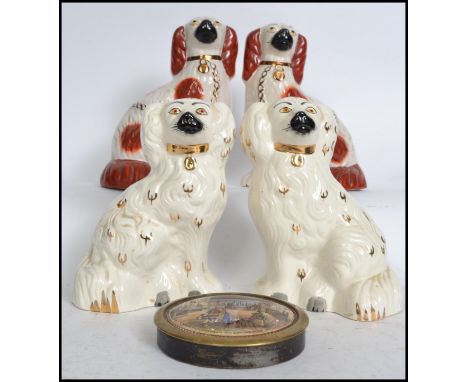 Two pairs of ceramic fireside dogs 19th and 20th century together with a 19th century framed pot lid. Measures:  24cm high. 