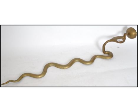 An unusual North African gilt metal wall sconce candelabra in the form of a snake - adder having single sconce atop