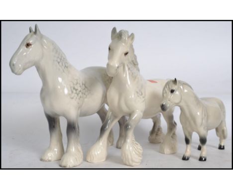 Two Beswick ceramic Shire horses, both in the grey colourway together with a Beswick Shetland pony also in the grey colourway
