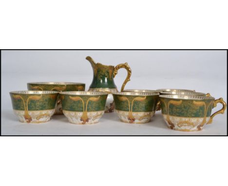 An early 20th century decorative Art Nouveau French tea service in green white and gilt finish comprising cups, saucers, plat