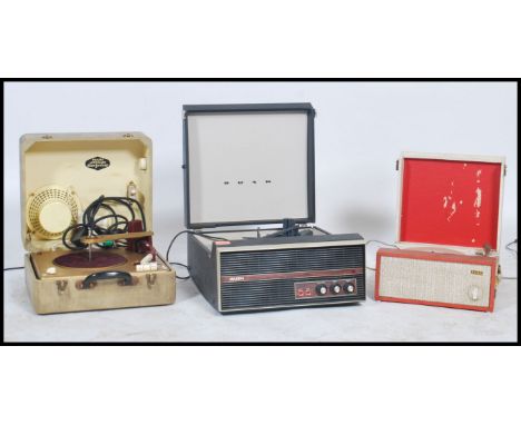 A vintage mid 20th century Bush vinyl record player having a BSR 4 speed deck set in a two tone case with Bush badge to front