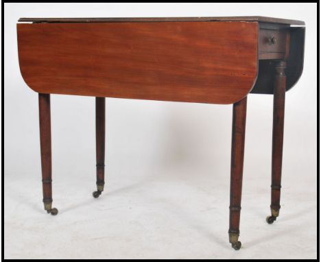 A 19th century mahogany drop-leaf Pembroke table of rectangular form, with triple-reed edge, single frieze drawers , raised o