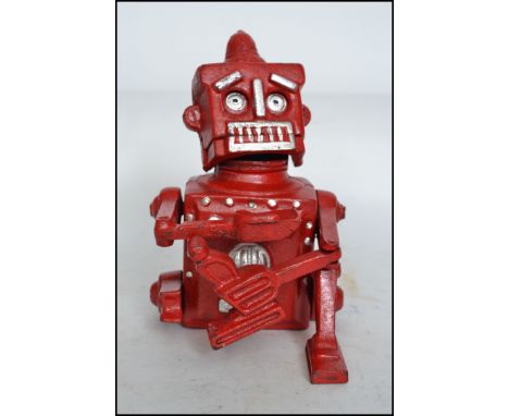 A vintage style cast iron Robert The Robot 1950 money bank in red being stamped Hubles to base. Measures:  19cm high. 