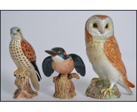 A group of three Beswick ceramic bird figures to include Kingfisher, Kestrel and Barn Owl. Measures:  19cm high. 