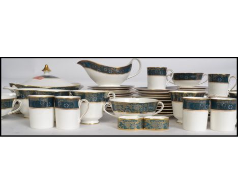 A Royal Doulton ceramic dinner and tea service in the Carlyle pattern. To include cups, saucers, plates, dinner plates, bowls