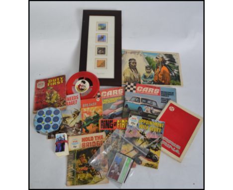 A collection of retro and vintage items to include a Rubiks Clock, comics, stamps, car magazines etc. Measures: 38cm high.