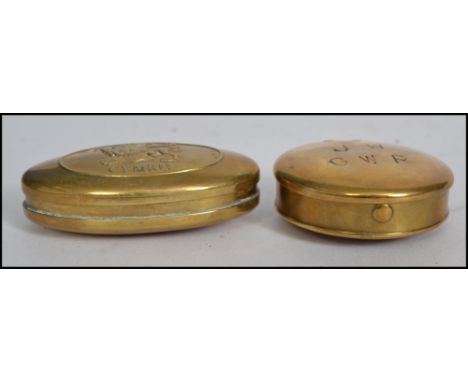 A vintage 20th century GWR railway transport related brass snuff box of circular form being stamped GWR JW along with a snuff