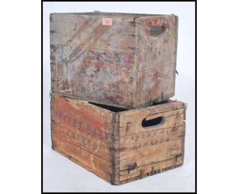 A pair of vintage mid century wooden advertising beer bottle crates, each with notation for Watney Mann. Some with remains of