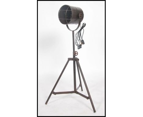 A vintage retro industrial style metal tubular tripod floor  spot lamp, having an adjustable tubular frame.
