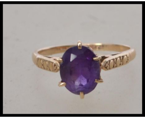 A ladies 9ct gold amethyst set single stone ring. The oval amethyst being claw set, marked 9ct gold to inside of the shank. T