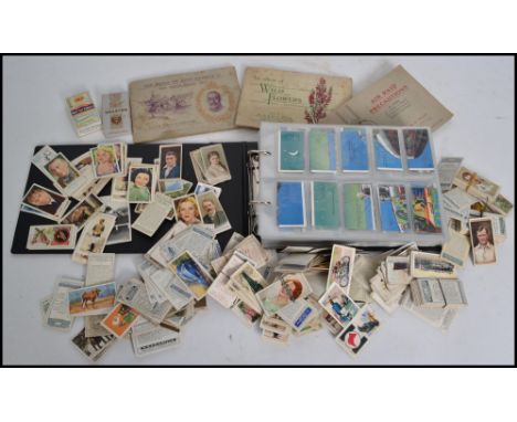 A collection of vintage cigarette cards in album to include Ardarh, Phillips, Wills, Players etc . along with a box of other 