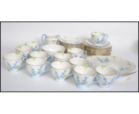 A 20th century Bone China tea service by Standard China in the forget me not pattern consisting of trio's side plates creamer