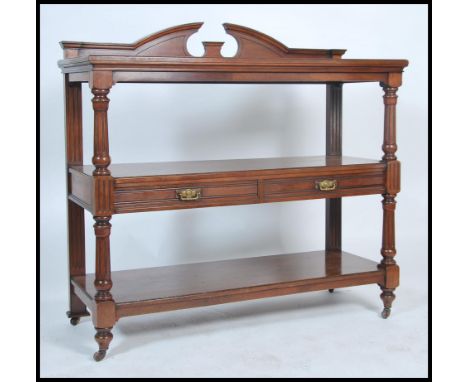 A 19th century Victorian mahogany 3 tier buffet sideboard. Raised on brown ceramic castors with reeded columns having fitted 