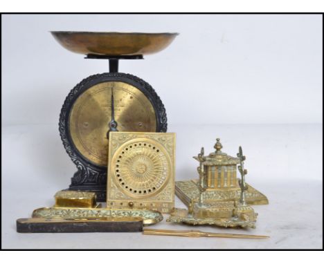 A collection of brass wares to include Victorian desk tidy, pen tray, sundial, salter scales, spirit measure and other items.