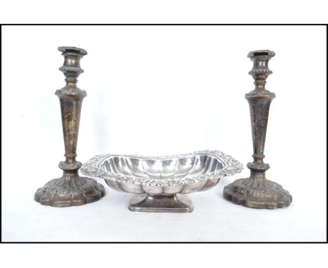 A Victorian silver plate on copper bread dish having a lobed rectangular bowl with rococo foliate tray edges and raised on a 