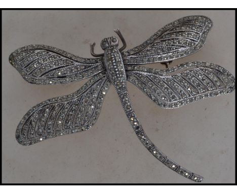 A spectacular large 925 silver and marcasite articulating dragonfly brooch pin with roller clip clasp. Marked 925. Measures 7