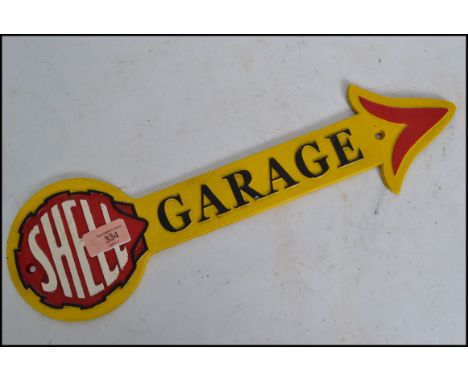 A vintage style painted cast iron advertising point of sale garage sign for Shell in the form of an arrow. Measures: 42cm wid