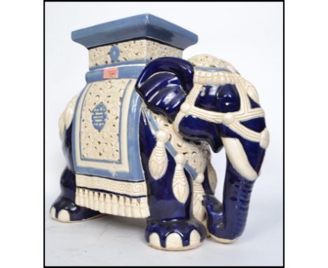 A large elephant ceramic plant stand in white and blue with plinth top dating to the 20th century