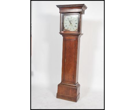 A 19th century long case grandfather clock having an oak trunk having a columned hood with gilded caubles and a cross banded 