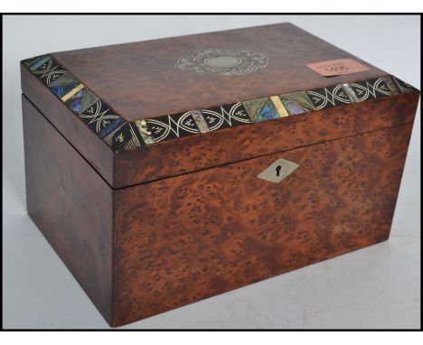 A 19th century Regency yew wood and abalone tea caddy of square form having a hinged top with abalone detailing. The hinged t