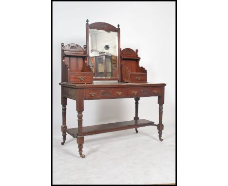 An Edwardian mahogany duchess dressing table raised on turned legs with reeded drawers to front. Above a swing mirror with tr