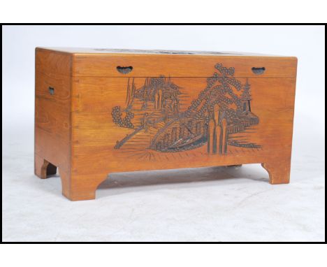 A mid century camphor wood Chinese trunk / blanket box having panel sides with hinged top, all over carved details 56x101x50c