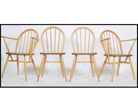 A set of four vintage 20th century retro Ercol light beech and elm dining chairs, two being carver chairs, having panel seats