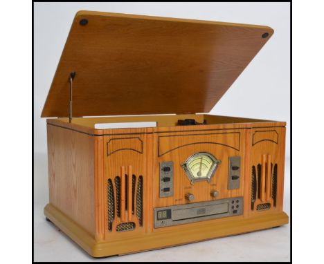 A vintage style wooden cased vinyl record, CD player and radio having a hinged lid to top and stylistic detailing to front. M