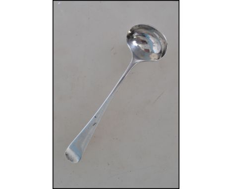 A unusual hallmarked silver Georgian miniature chocolate ladle having a rounded bowl with a Hanoverian pattern handle. Makers