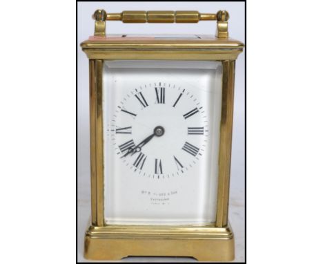 A vintage early 20th century French brass cased carriage clock retailed by William Bruford and Son Eastbourne striking on a g